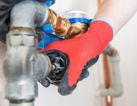 Residential Water Pipeline Valve Residential Water Pipeline Valve Closing. Plumbing Industry Concept. Caucasian Plumber Worker.
